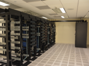 What Is Cloud Computing? Types, Benefits and Examples Two rows of server racks with blue indicator lights receding down a data centre corridor