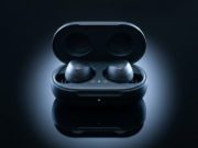 How Does Bluetooth Work? Versions, Range and Fixes Wireless earbuds in an open charging case on a dark reflective surface