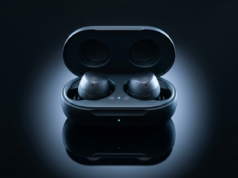 How Does Bluetooth Work? Versions, Range and Fixes Wireless earbuds in an open charging case on a dark reflective surface