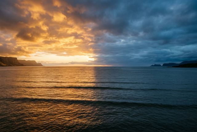 Ocean horizon split between warm golden light and cool blue shadow