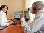 Hearing Aids and Hearing Rehabilitation: What to Know Audiologist performing a hearing test on a man with hearing loss