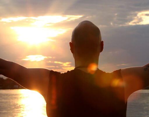 Chakras Explained: Origins, the Seven Centres and What Evidence Says Silhouette of a person sun gazing against a bright sky