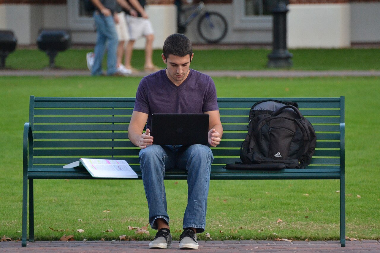 Homework and study notes beside a laptop, the typical student workflow with AI tools
