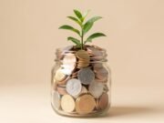 Compound Interest Explained: How Small Savings Grow Over Time Small plant growing from a jar of coins, representing compound interest
