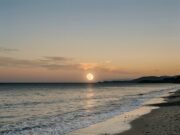 How Tides Work: Why the Moon and Sun Pull the Ocean Ocean waves rolling onto a beach at low tide with the Moon in the sky